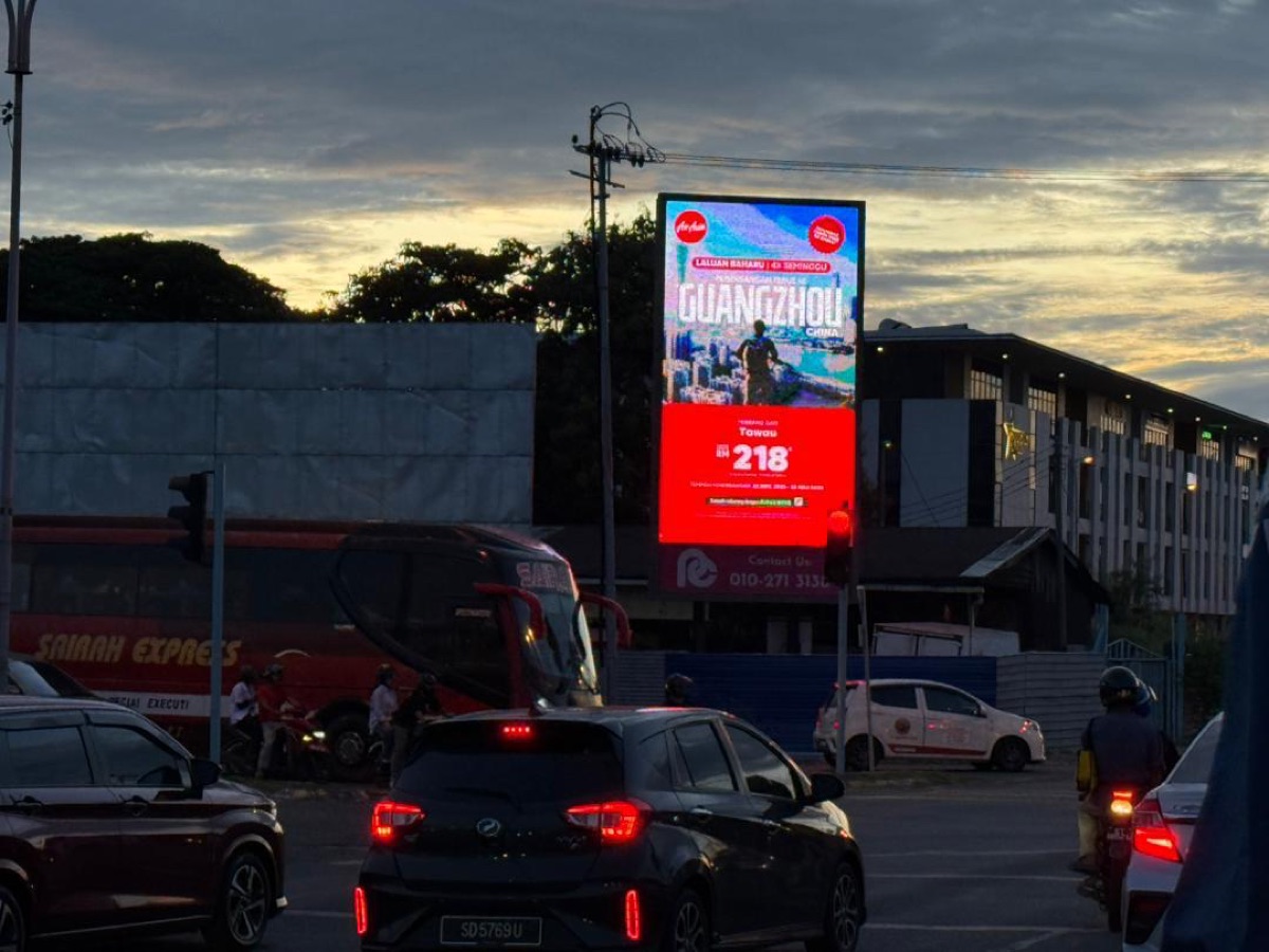 PCSB LED Billboard in Tawau at busy intersection with AirAsia advertisement